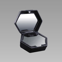 Black hexagonal Intake travel case open, showing the built-in mirror and steel band plate