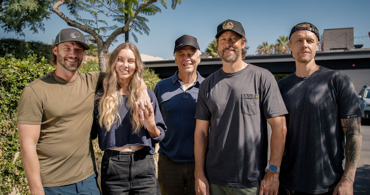 The Intake family standing together outside in the sun